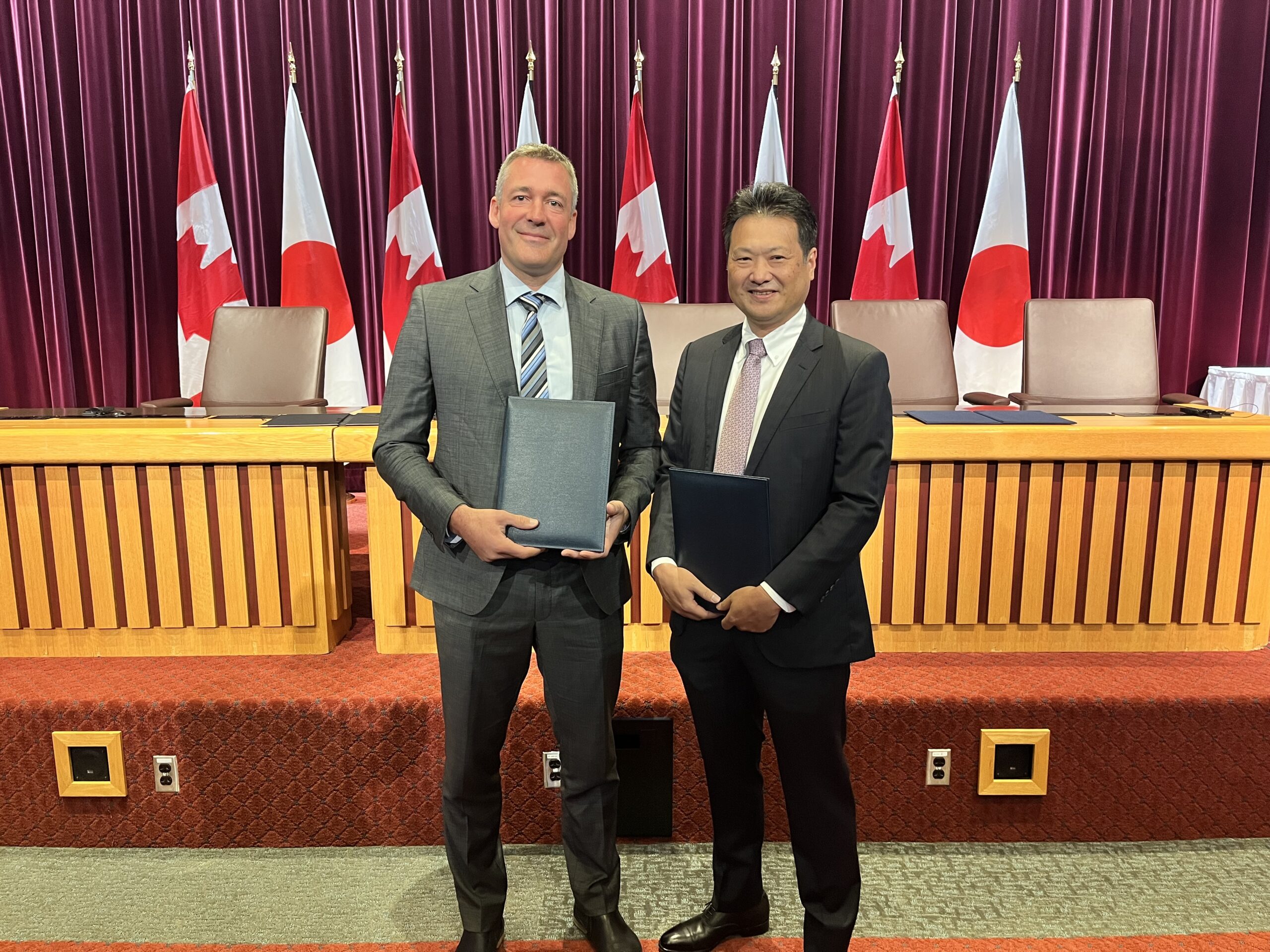 Canadian executive and Japanese executive meet in a Canadian government office